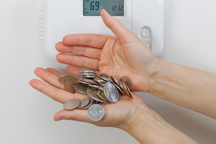 The coins and hands represent the money a person saves when taking advantage of the air conditioner.