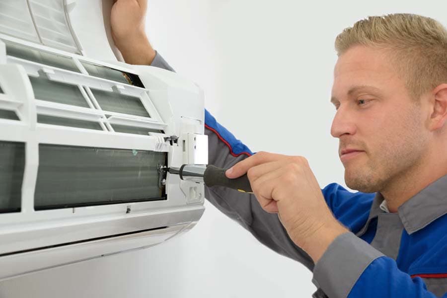 Technician Repairing Air Conditioner, Do I Really Need an Air Conditioner Tune-Up? | Precise Comfort