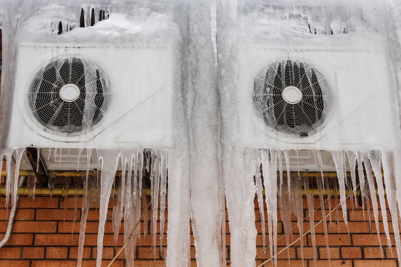 Outdoor air conditioning unit covered in ice.