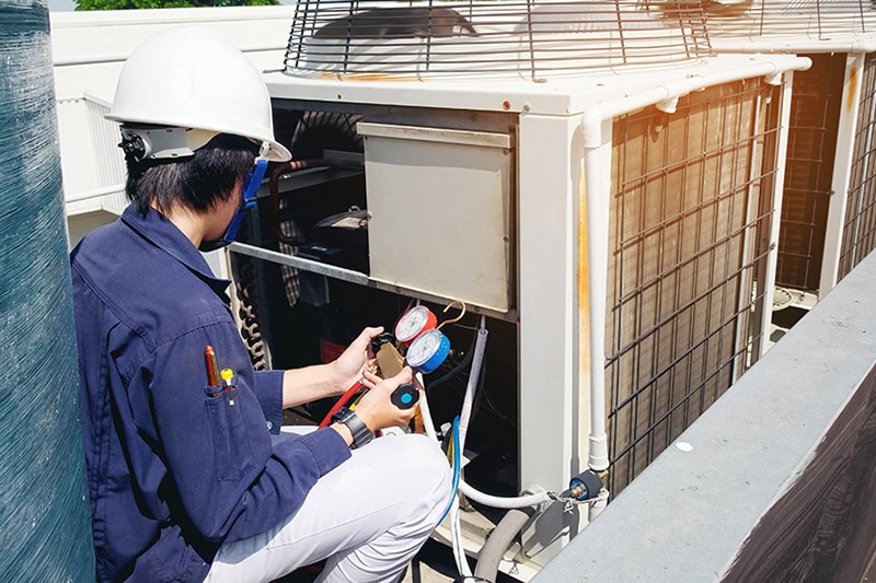 A technician working on an AC unit.